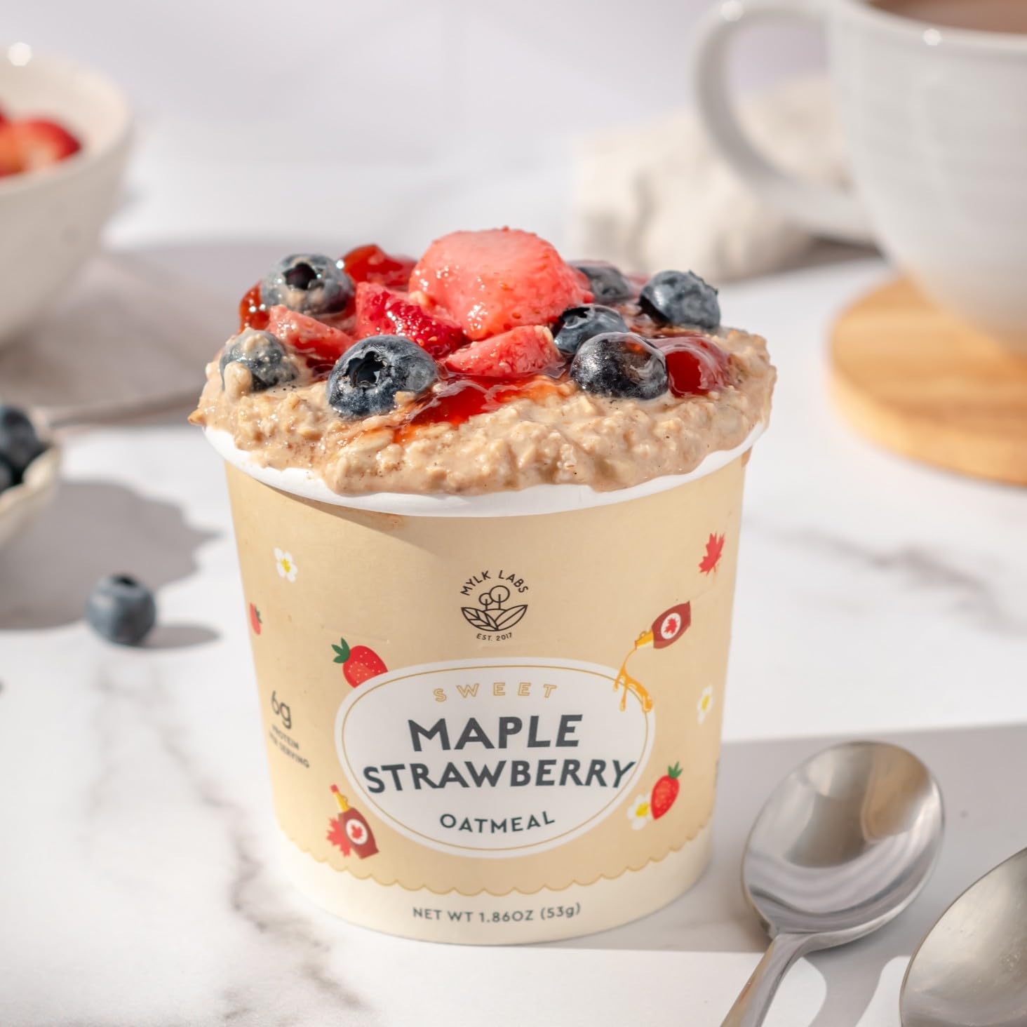 Bowl with spoon of prepared Mylk Labs oatmeal ready to enjoy.