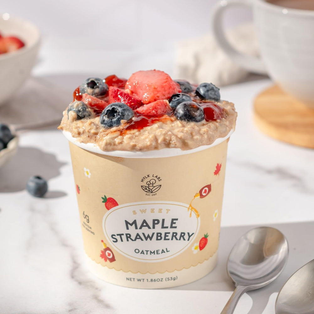 Bowl with spoon of prepared Mylk Labs oatmeal ready to enjoy.