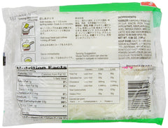 Noodles being poured into a steaming bowl for serving.