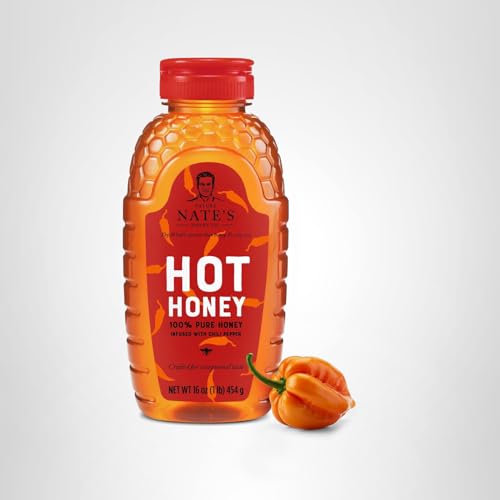 Nate's Hot Honey with habanero flakes closeup, showing fiery pepper specs.