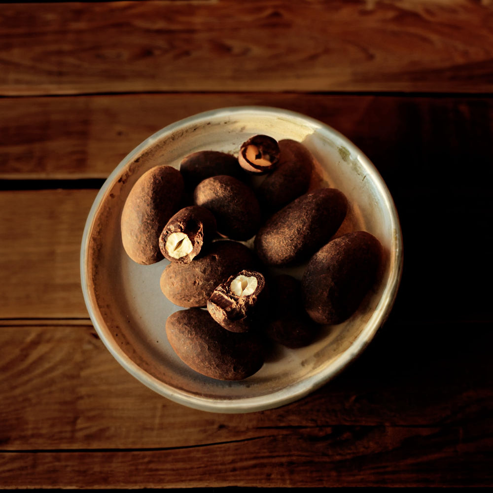 Naturanic Brazilian dark chocolate covered nuts snack-time shot, convenient on-the-go treat.