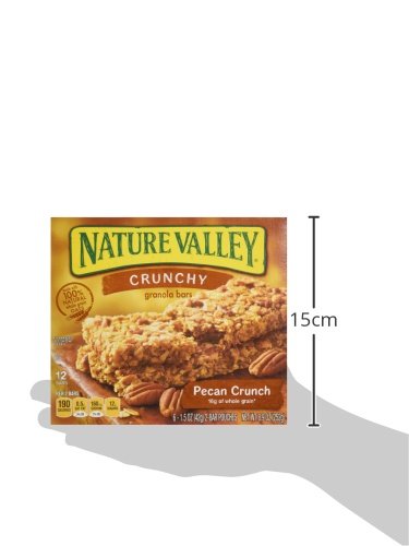 Nature Valley Pecan Crunch breaking bite, reveals real pecans.