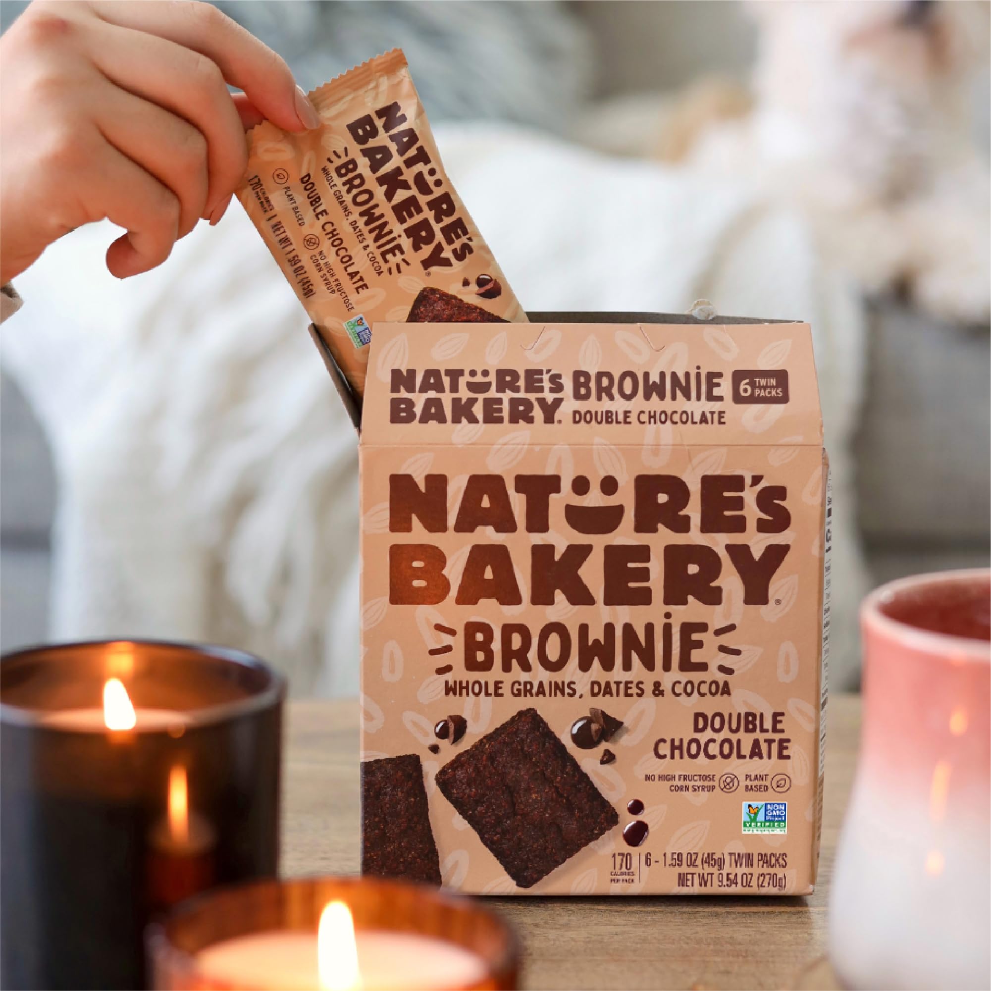 Nature's Bakery cozy snack moment on a couch.