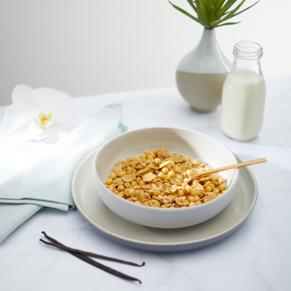 Serving with milk and berries featuring Nature's Path Sunrise Crunchy Vanilla cereal.