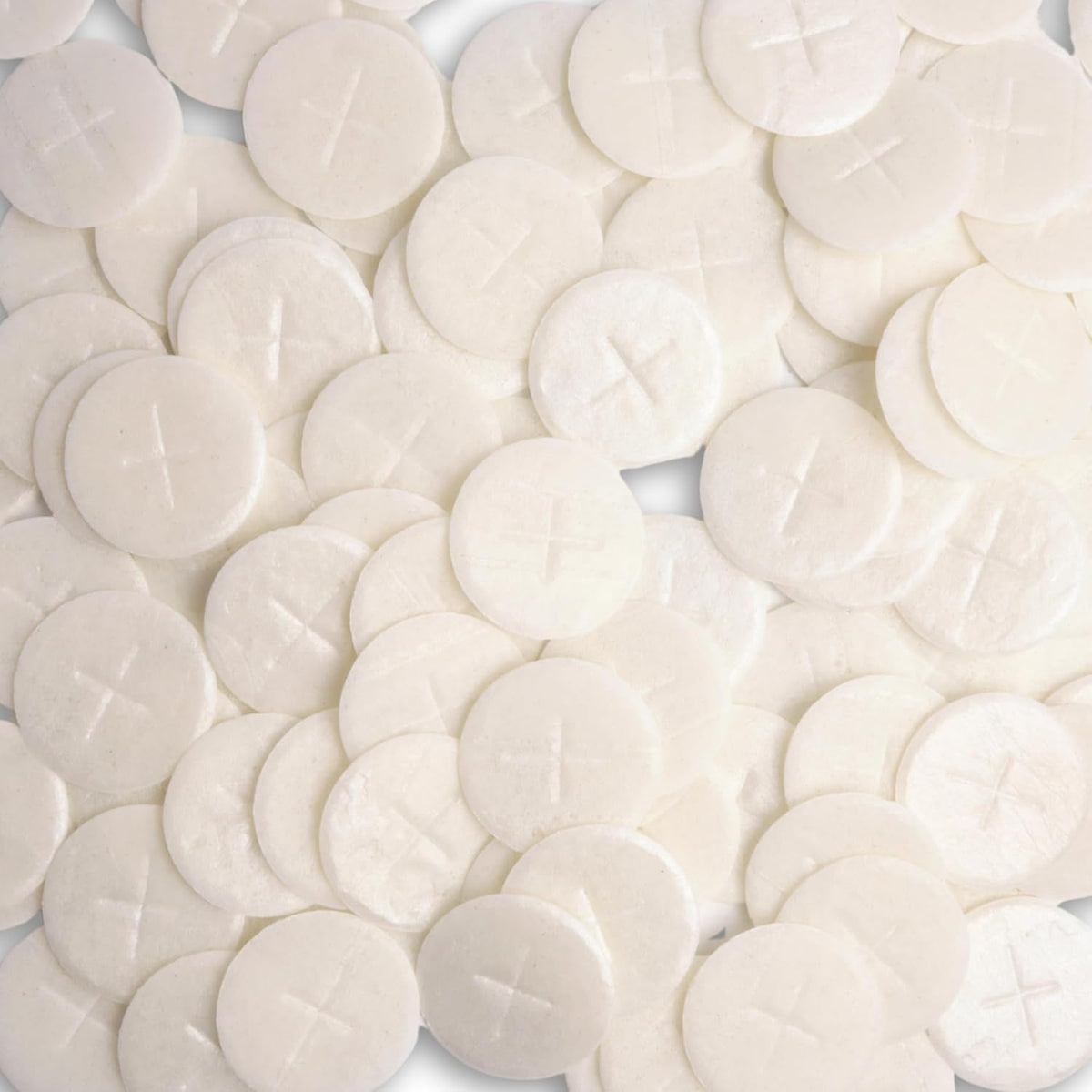 Needzo altar bread with white cross design, ideal for Eucharist rites.