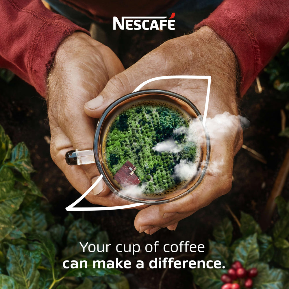 Office desk setup with NESCAFÉ Clásico Dark Roast mug during a break.