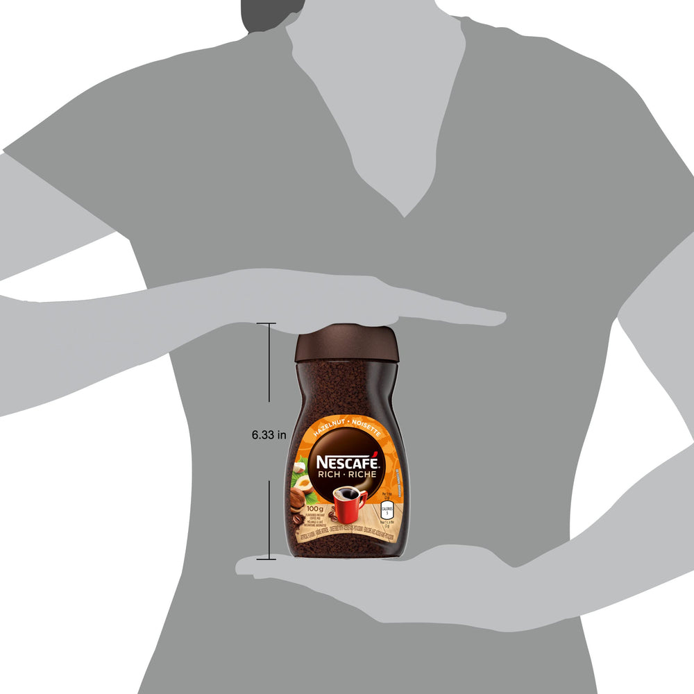 Spoon resting beside NESCAFÉ Rich Hazelnut emphasizes portion control and freshness.