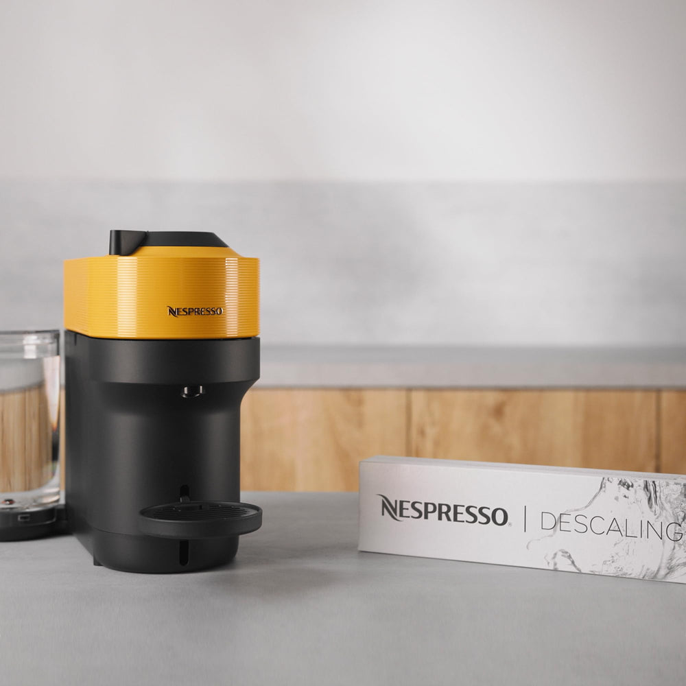 Nespresso descaling kit pouches close-up demonstrating convenient, ready-to-use solution