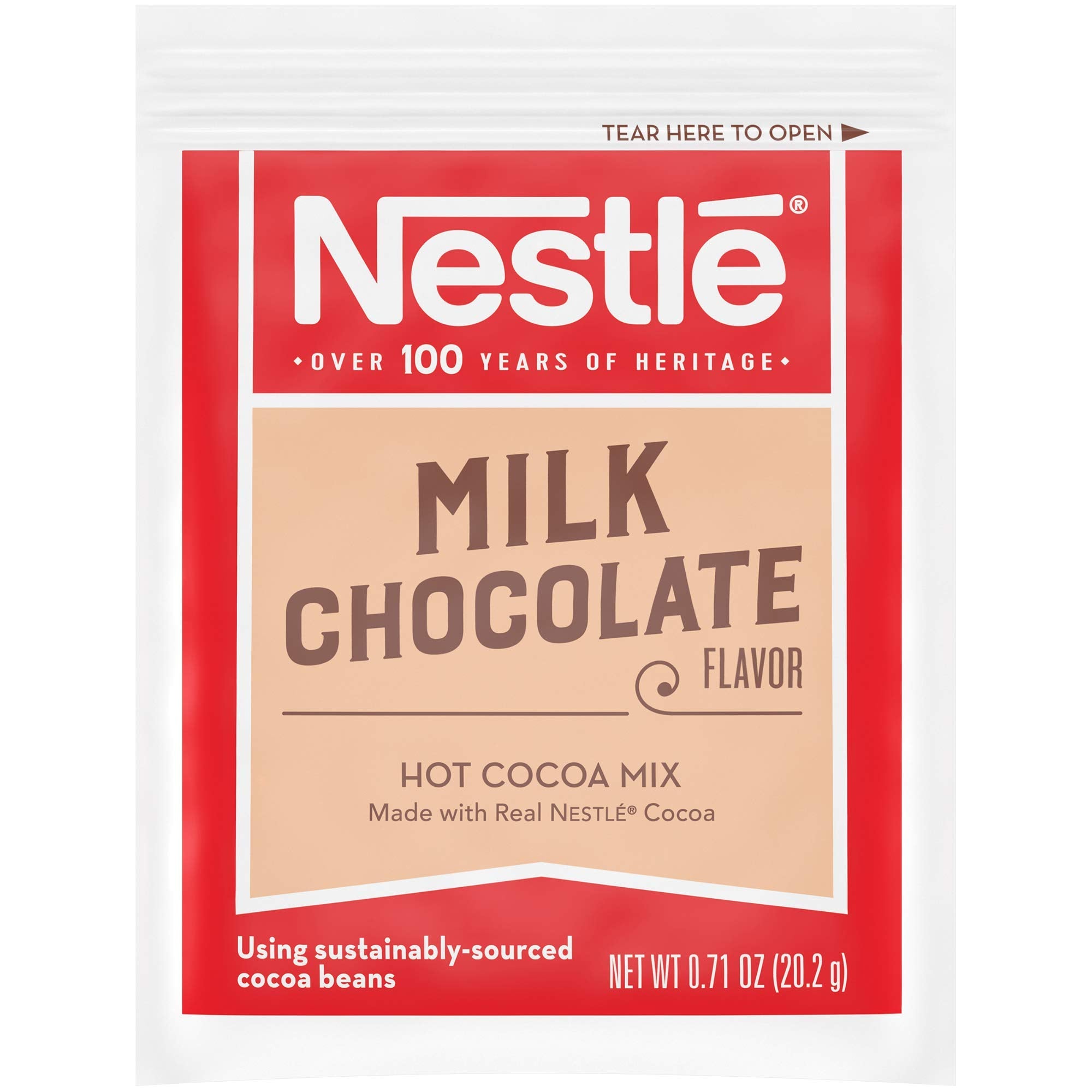 Nestle Hot Cocoa sachets over hot milk, ready to mix quickly.