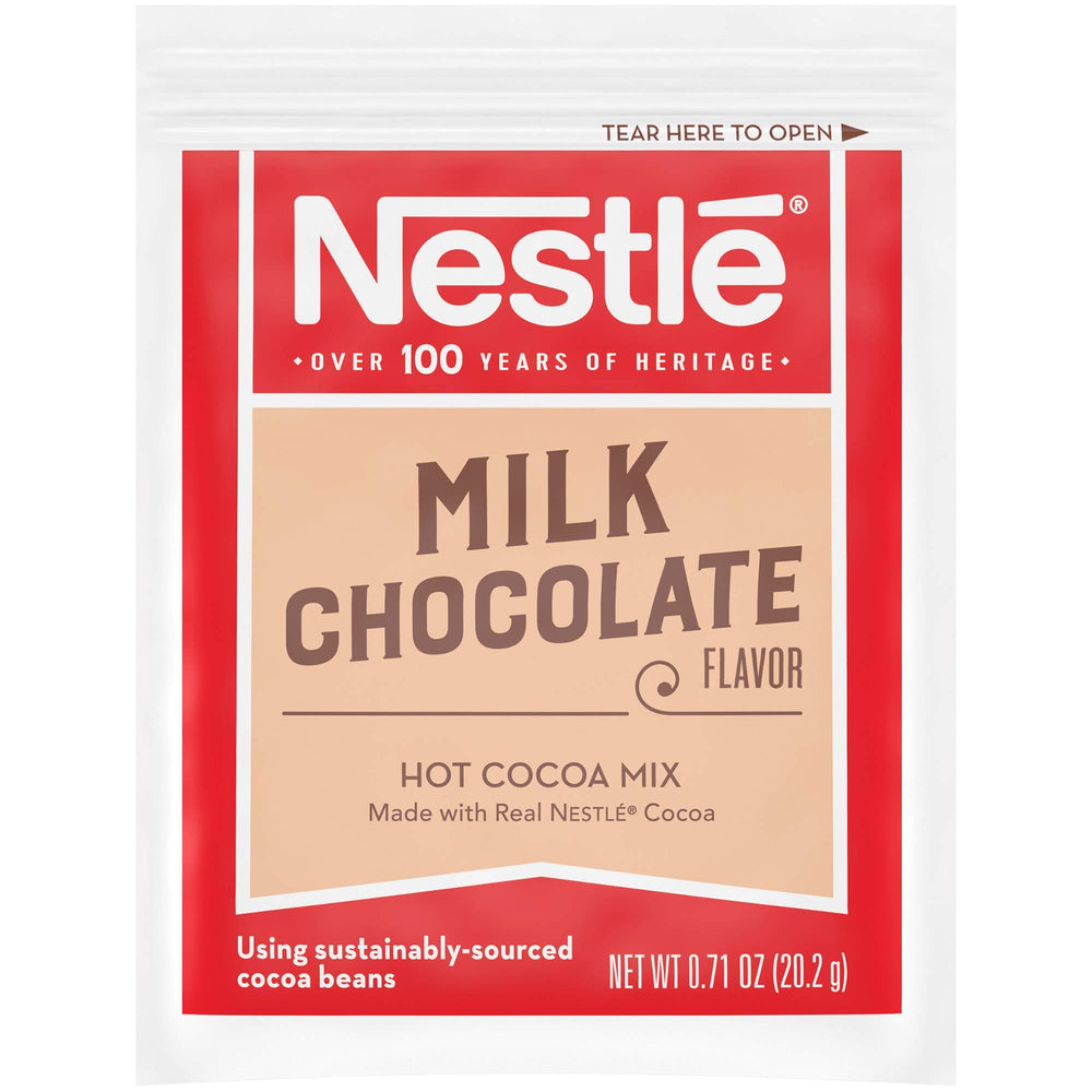 Nestle Hot Cocoa sachets over hot milk, ready to mix quickly.