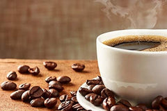 New England Coffee ground beans close-up highlighting 100% Arabica