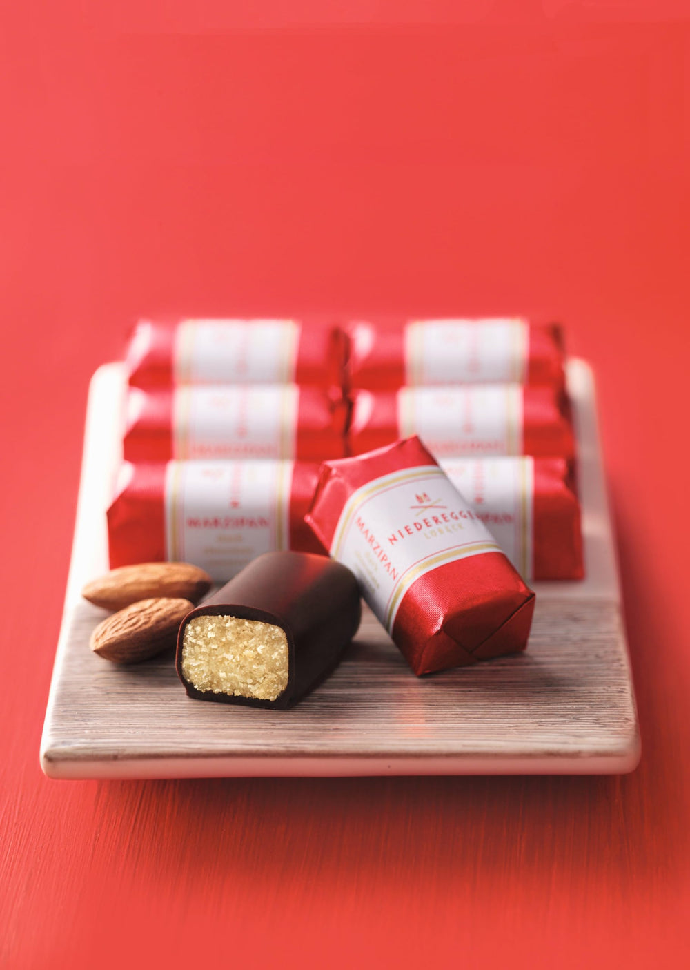 Eight Niederegger marzipan pieces coated in crisp and dark chocolate for celebrations.
