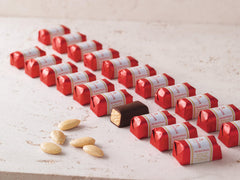 Niederegger marzipan gift box opened, revealing eight chocolate-coated pieces to share.
