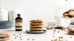 Nielsen-Massey vanilla extract being poured for smooth batter integration