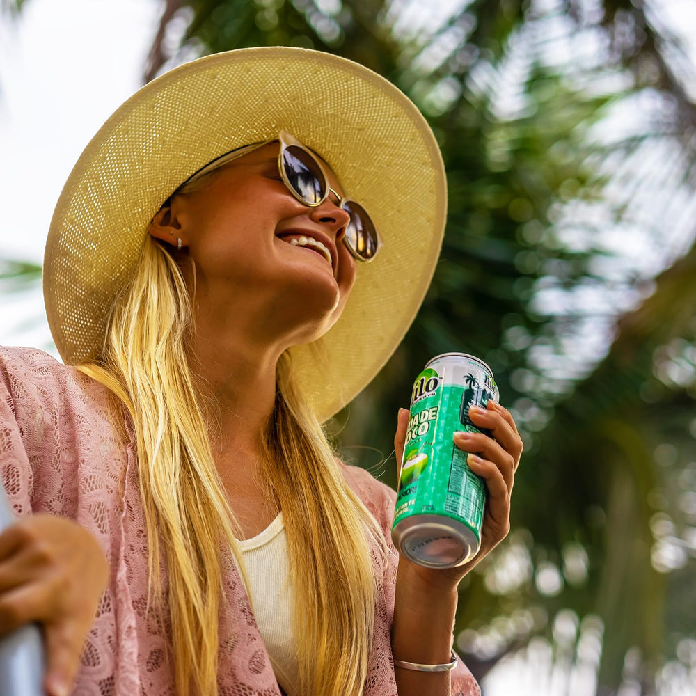 Tropical scene featuring NILO coconut water with pulp for ready-to-drink refreshment.