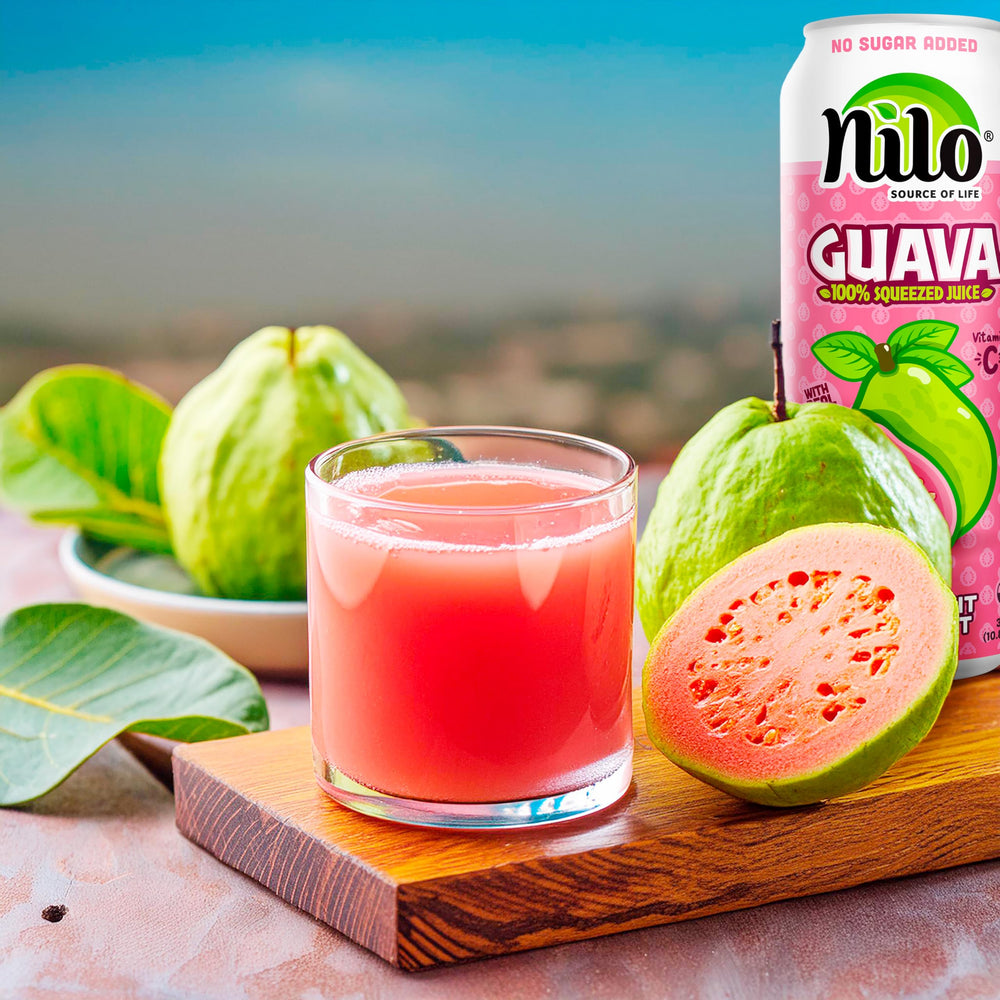 Chilled NILO Pink Guava Juice in a glass, inviting tropical aroma.