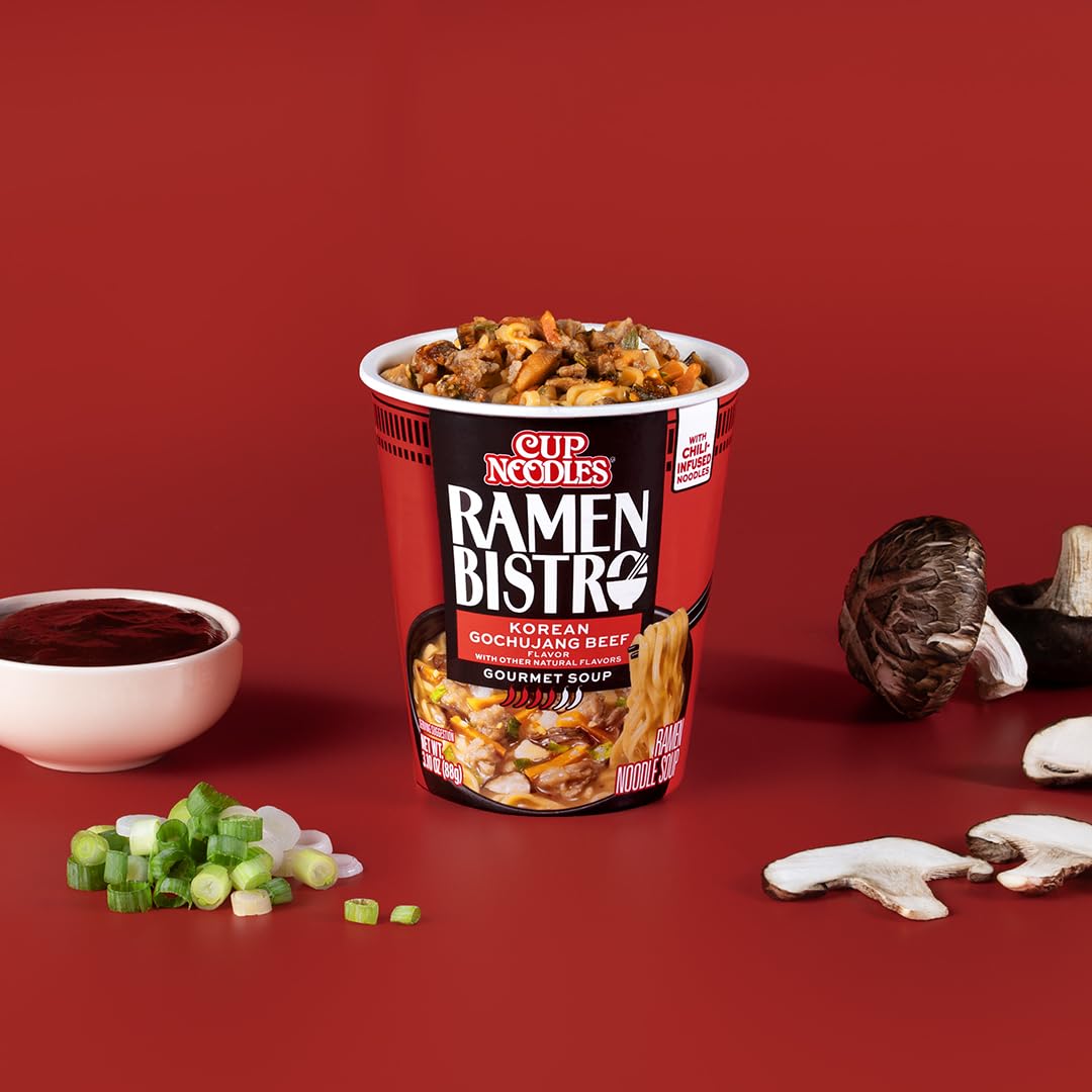 A bowl-level view of NISSIN Ramen Bistro with bok choy and vegetables.