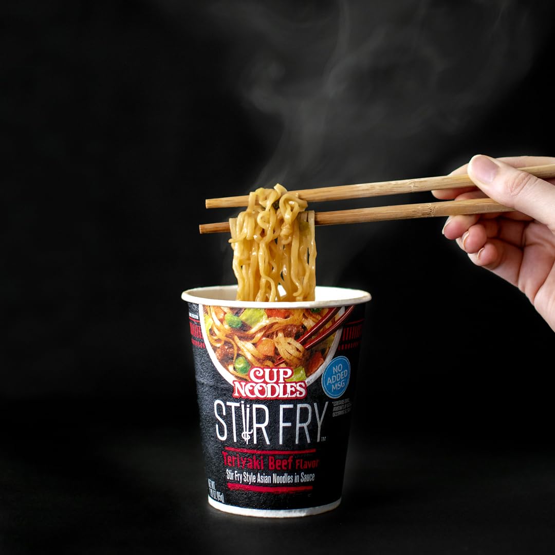 Microwave-ready NISSIN Cup Noodles Stir Fry Teriyaki Beef noodles close-up.
