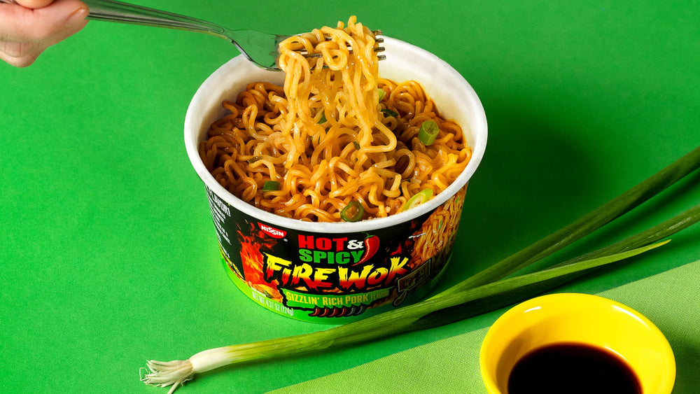 NISSIN Hot & Spicy Fire Wok pork broth base close-up for hearty satisfaction.