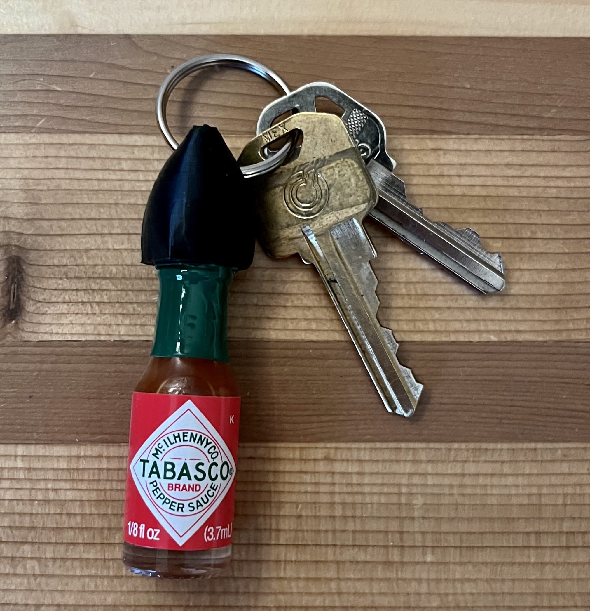 Nomad Enterprises mini Tabasco bottle on keychain for portable flavor on the go
