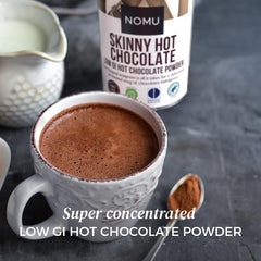 NOMU Skinny hot chocolate cup steaming for a cozy, low-calorie indulgence.
