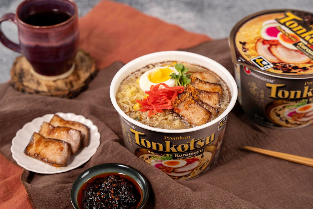 Nongshim tonkotsu broth swirl and noodles close-up.