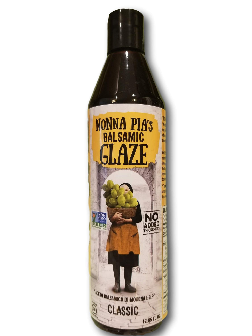 Nonna Pia's Balsamic Glaze bottle on a kitchen counter, perfect for finishing meats and vegetables.