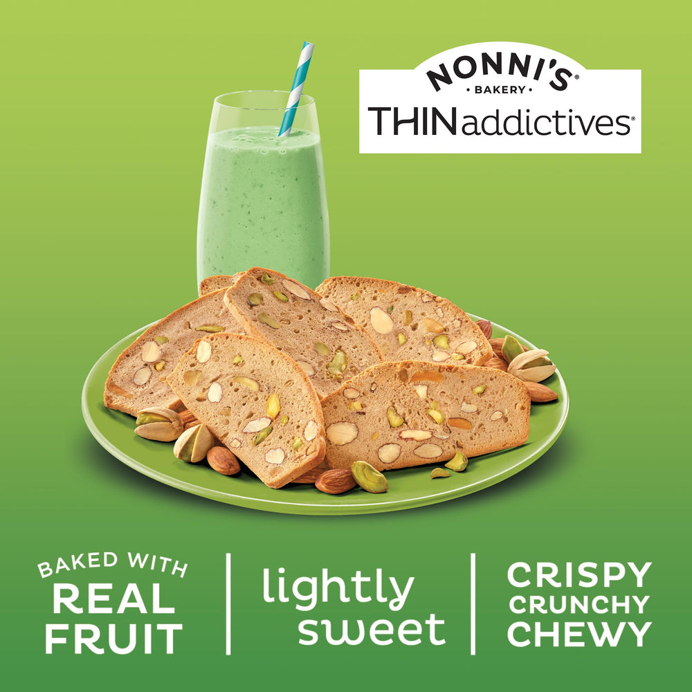 Nonni's pistachio almond crisps beside coffee for pairing.