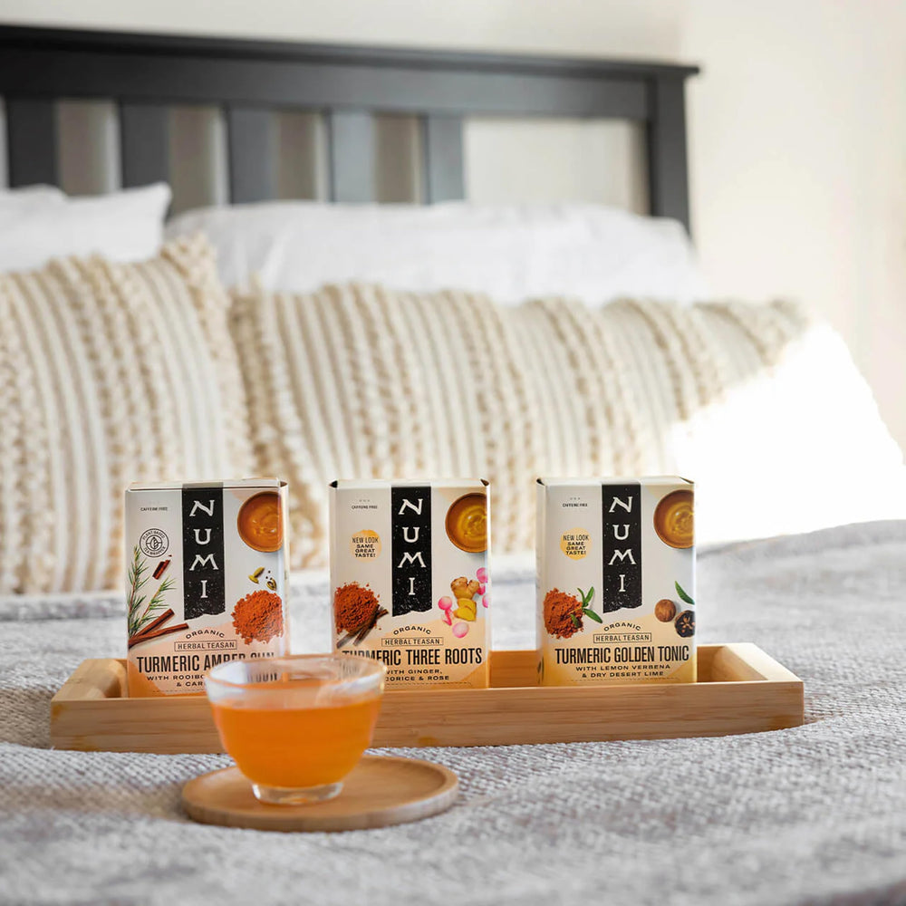 Numi Three Roots turmeric tea on a warm kitchen shelf suggests cozy moments