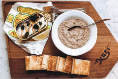 Opened can reveals oil-soaked fillets ready for quick plates.