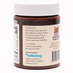 Nutlicious spread on spoon showing silky texture.