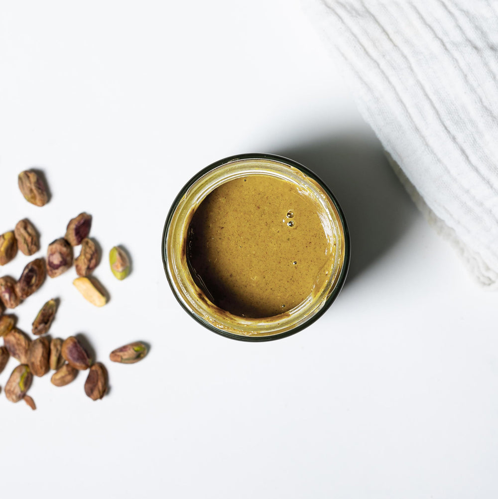 Nutural World pistachio butter closeup nuts highlights single-ingredient purity.