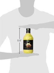 Oak Hill Farms Vidalia Onion Vinaigrette in a glass bottle beside roasted dishes