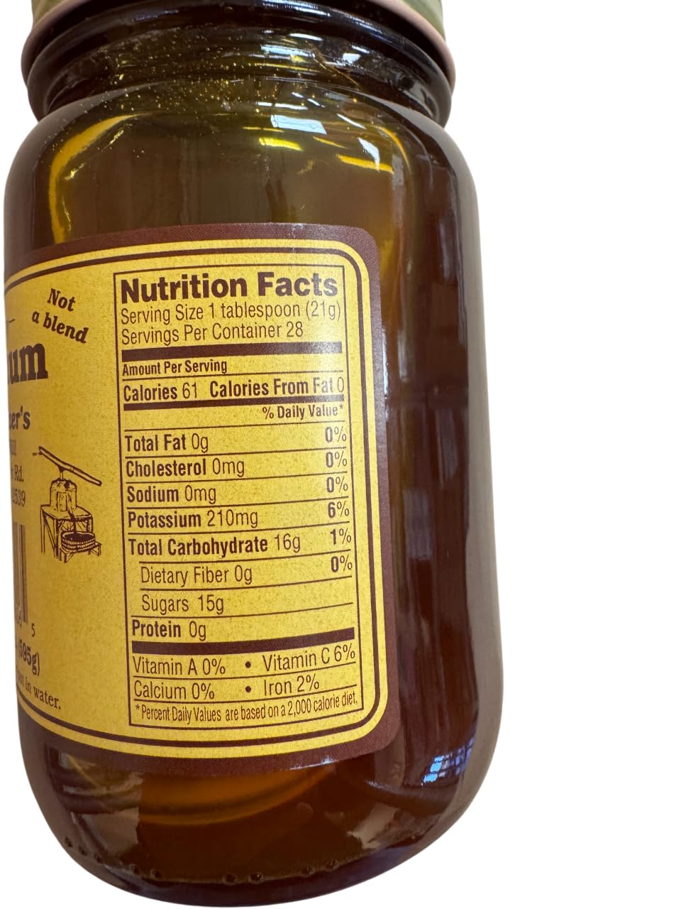 Oberholtzer's Pure Kentucky Sorghum pour demonstrates smooth flow for pancakes or glaze.