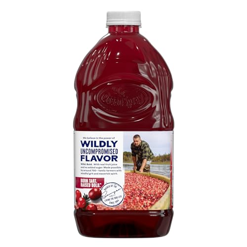 Bottle on kitchen counter with fresh cranberries and cherries