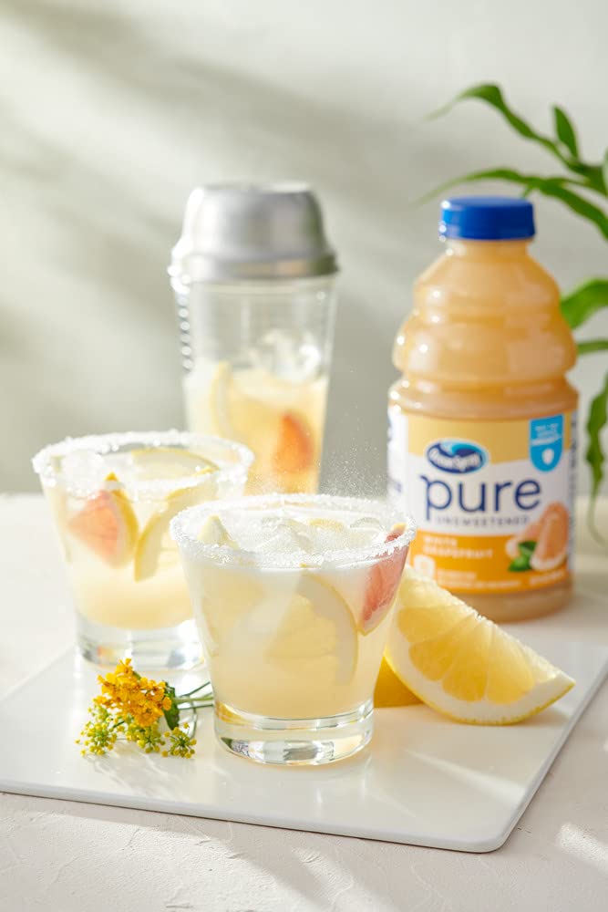Ocean Spray Pure Unsweetened White Grapefruit Juice bottle with ice and citrus slices.