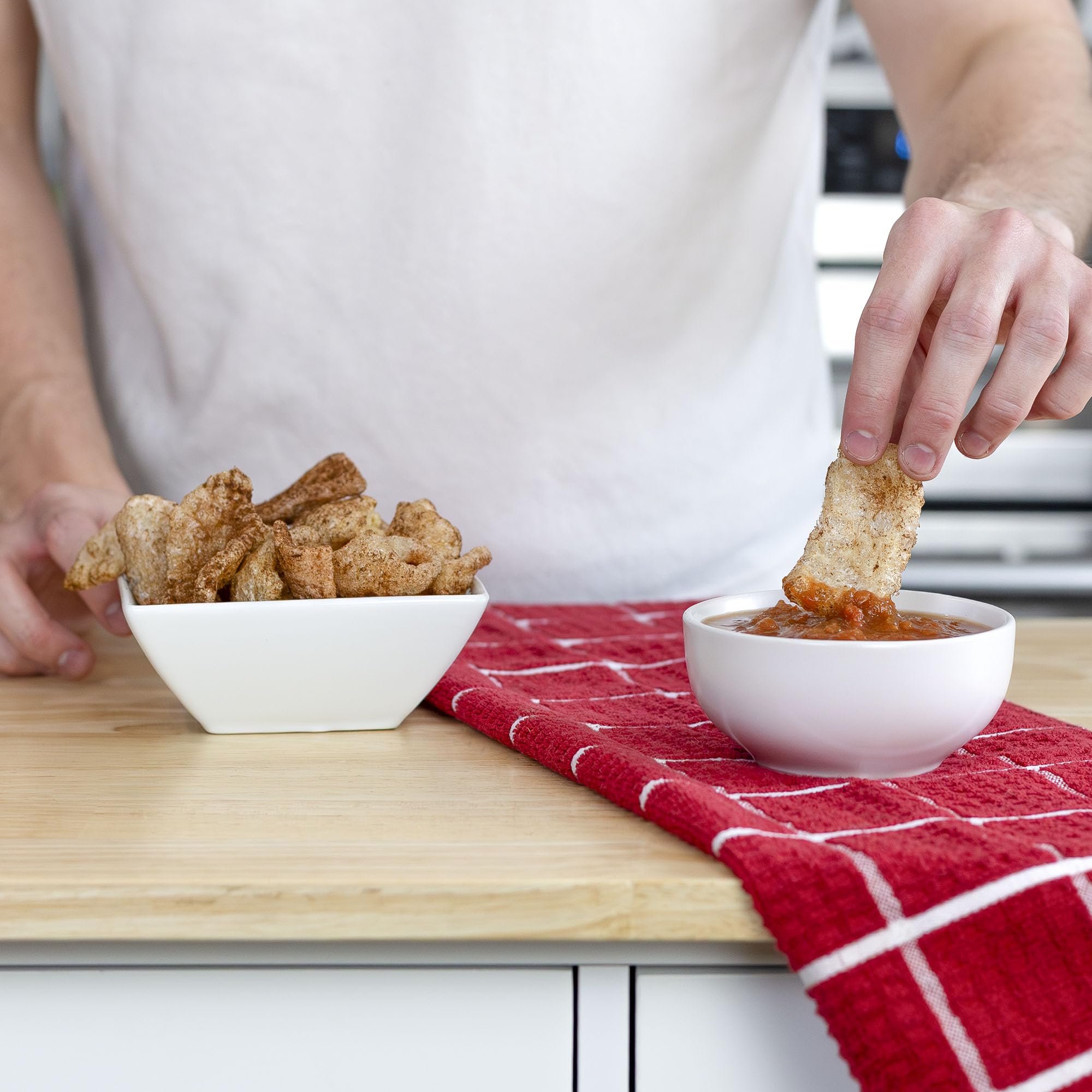 Ol' Uncle Porkers Cinnamon Churro rinds topping yogurt for a crunchy, keto-friendly treat.