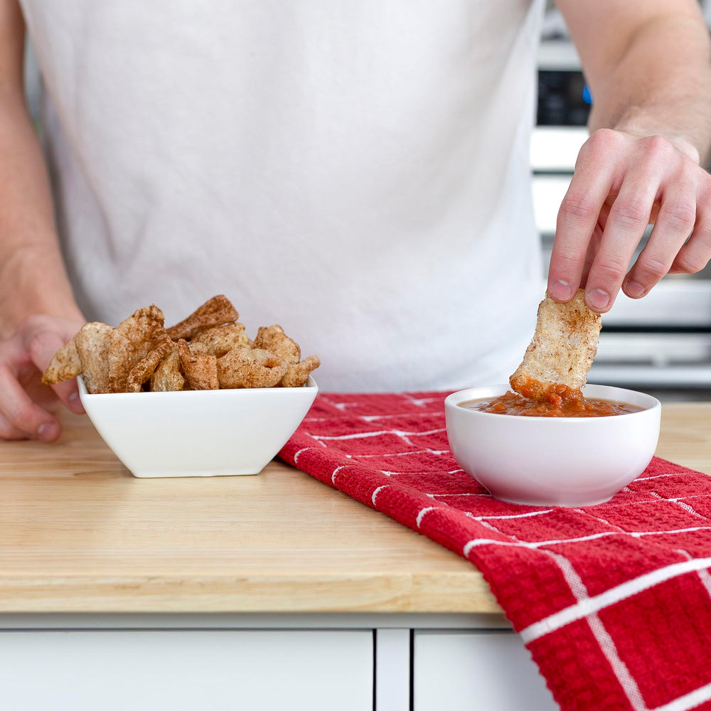 Ol' Uncle Porkers Cinnamon Churro rinds topping yogurt for a crunchy, keto-friendly treat.