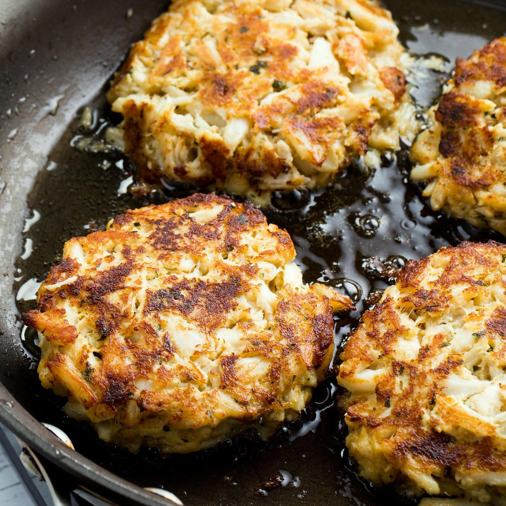 Formed crab cakes shaped from OLD BAY mix and crab meat before cooking.