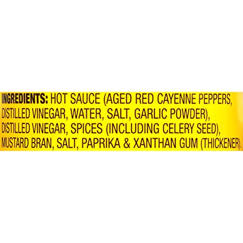 Pouring OLD BAY Hot Sauce for a spicy kick