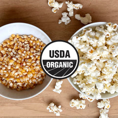 Olde World Popcorn non-GMO seal on packaging signaling clean ingredients.