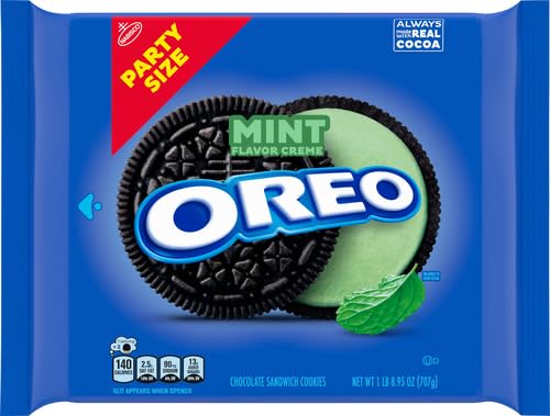 Dunk-ready OREO Mint Creme cookies with a glass of milk.