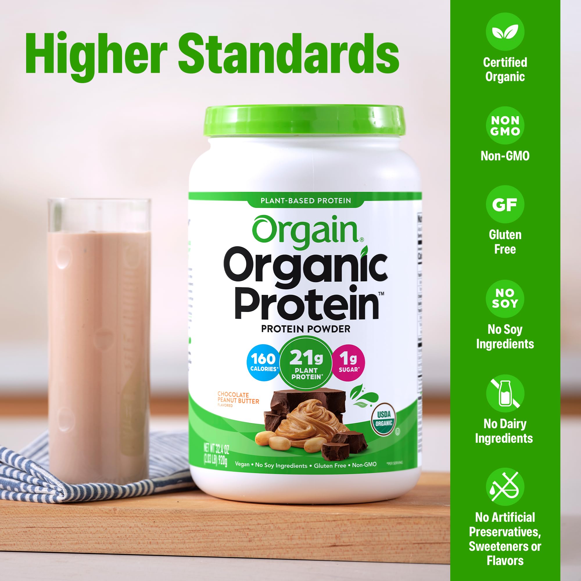 Pouring chocolate peanut butter shake with Orgain powder in a tall glass.
