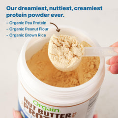 Scoop of Orgain Vanilla Almond Butter Protein Powder beside a smoothie bowl.
