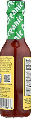 Pouring Organic Harvest Habanero pepper sauce highlighting versatile heat for meals.