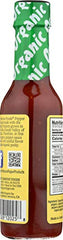 Pouring Organic Harvest Habanero pepper sauce highlighting versatile heat for meals.