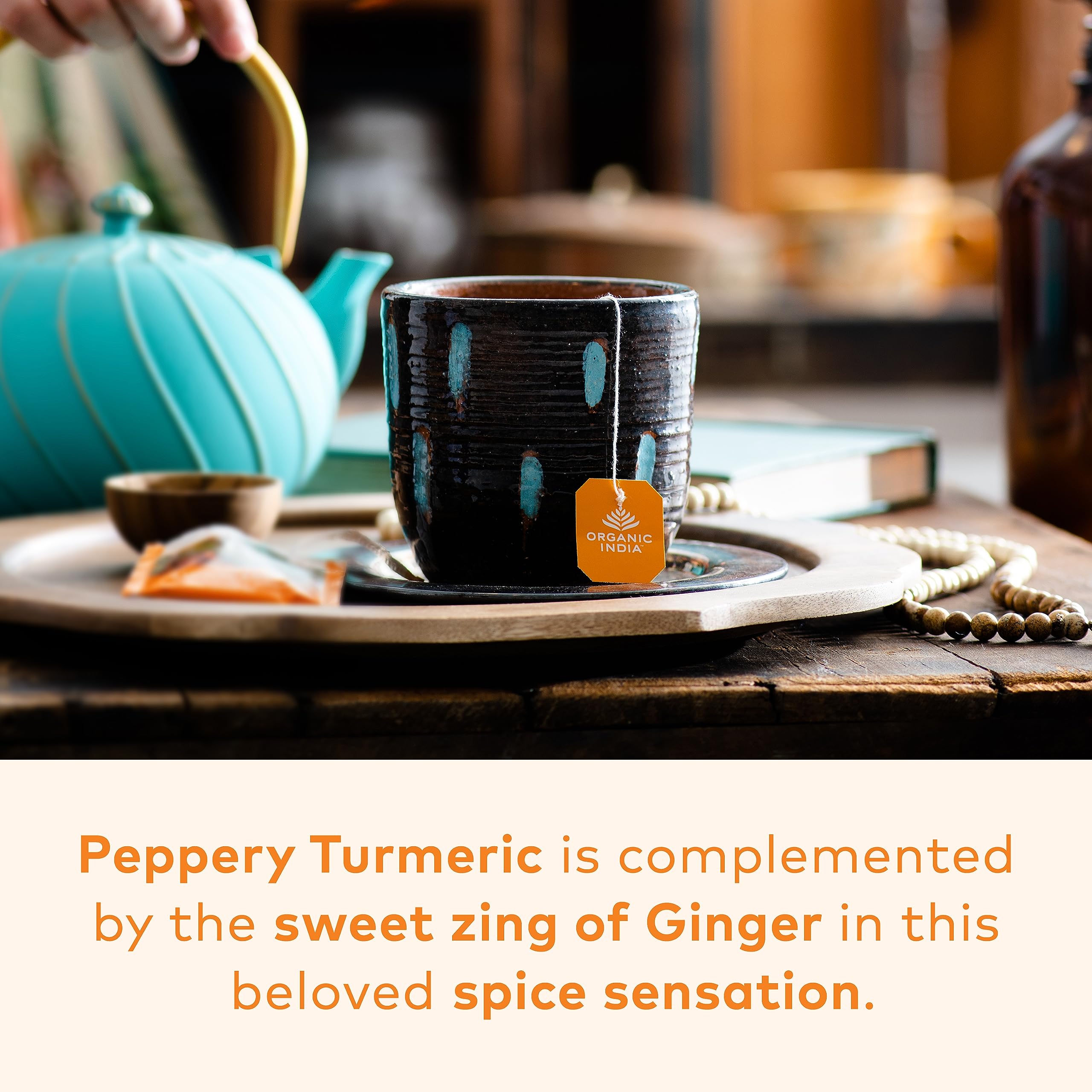 Warm cup of ORGANIC INDIA Tulsi Turmeric Ginger tea with spice aroma.