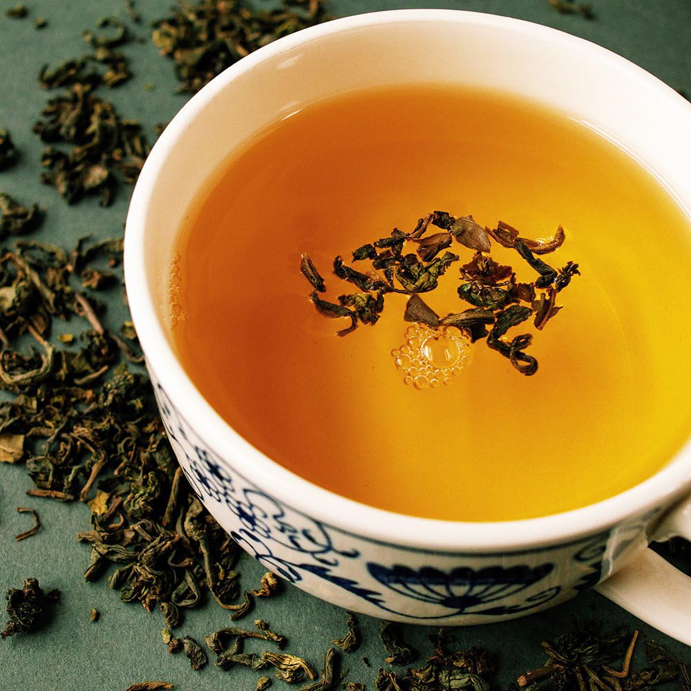 Organic Positively Tea Company Jasmine Green Tea brewed cup steam invites relaxation.