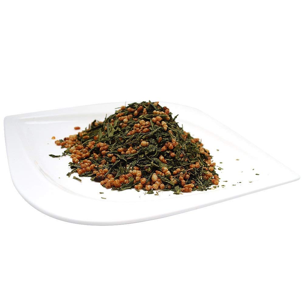 Organic Positively Genmaicha measuring scoop over leaves encourages precise brew strength