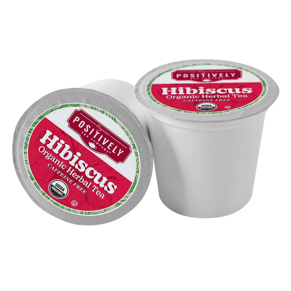 Organic Positively Tea hibiscus tea in a cup with vibrant red liquor for hot or iced.